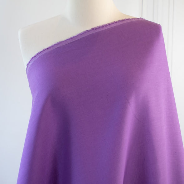 Perk up your summer wardrobe with some color! This soft English Violet shirt-weight linen would make a perfect layering piece. Nothing says summer style more than an open shirtdress over a column of white basics. So chic! This is also perfect for summer dresses and tops! Image of fabric draped on dressform.  
