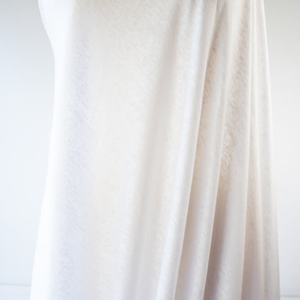 You'll love this white linen jersey knit from the NYC Designer whose designs are found in high end department stores.  This translucent linen jersey knit has a soft hand, mechanical stretch, and is light and flowy. A perfect fabric for Spring and Summer.  Image of fabric drape.