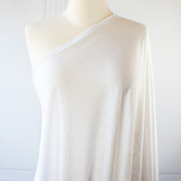 You'll love this white linen jersey knit from the NYC Designer whose designs are found in high end department stores.  This translucent linen jersey knit has a soft hand, mechanical stretch, and is light and flowy. A perfect fabric for Spring and Summer. Image on dressform