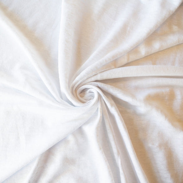 You'll love this white linen jersey knit from the NYC Designer whose designs are found in high end department stores.  This translucent linen jersey knit has a soft hand, mechanical stretch, and is light and flowy. A perfect fabric for Spring and Summer. 