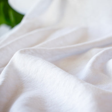 You'll love this white linen jersey knit from the NYC Designer whose designs are found in high end department stores.  This translucent linen jersey knit has a soft hand, mechanical stretch, and is light and flowy. A perfect fabric for Spring and Summer.  Close up image